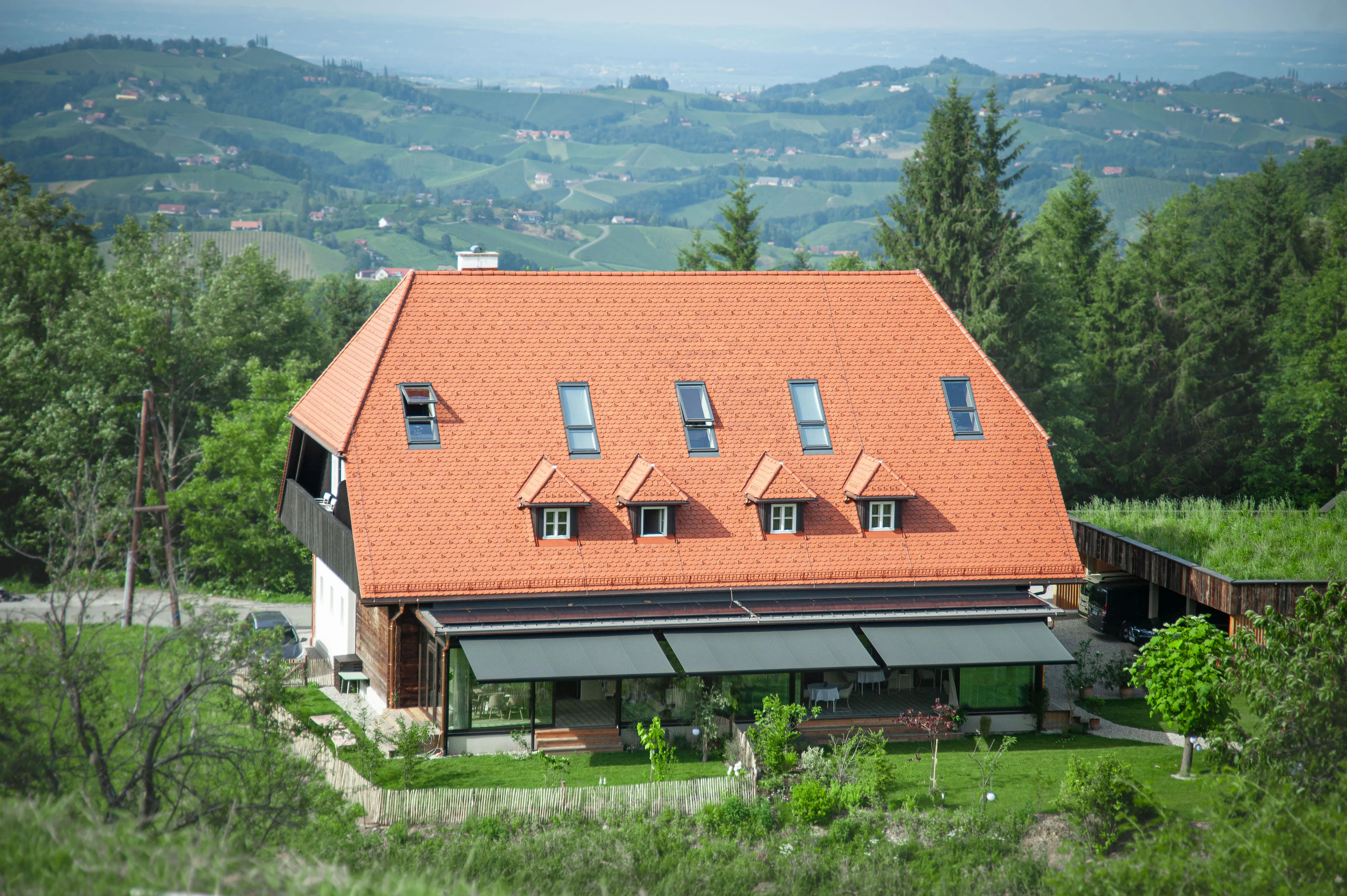 A photo of the guesthouse surrounded by the picturesque landscape of southern Styria.